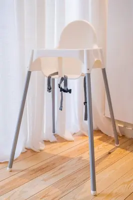 a white chair sitting on top of a wooden floor at New Apartment center of Trendy St Gille in Brussels