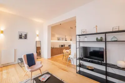 a living room with a flat screen tv and a living room at New Apartment center of Trendy St Gille in Brussels