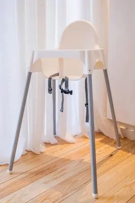 a white chair sitting on top of a wooden floor at New Apartment center of Trendy St Gille in Brussels
