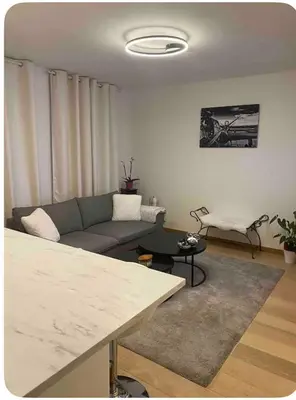 a living room with a couch and a table at Apparemment 1 chambre in Brussels