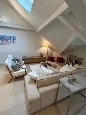 a living room with two couches and a table at Historic Charm Penthouse Leuven in Leuven