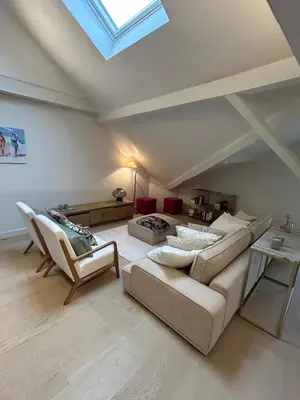 a living room with a couch and chairs and a skylight at Historic Charm Penthouse Leuven in Leuven
