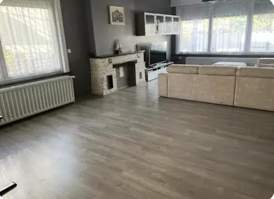 a living room with a couch and a fireplace at Dar Laila in Vilvoorde
