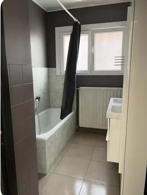a bathroom with a bath tub and a sink at Dar Laila in Vilvoorde