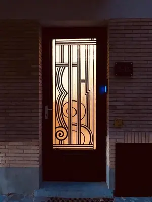 a door with a gate on the side of a building at Knus appartement centrum Gent in Ghent