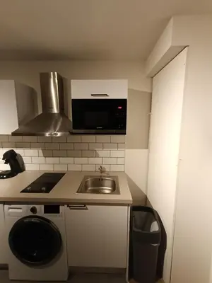 a small kitchen with a sink and a microwave at Localização privilegiada in Brussels