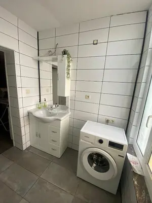 a bathroom with a washing machine and a sink at Sportpaleis afasdome in Antwerp