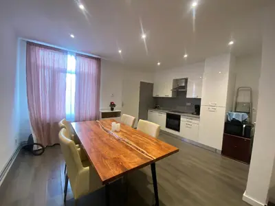 a kitchen and dining room with a wooden table and chairs at Sportpaleis afasdome in Antwerp