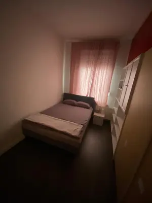 a small bedroom with a bed and a window at Sportpaleis afasdome in Antwerp