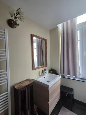 a white bathroom with a sink and a mirror at The Amber Lounge, 1040 Brussels in Brussels