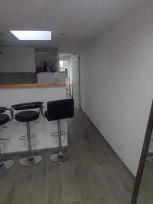 a room with two bar stools and a kitchen at best price apparemment budget brussels in Brussels