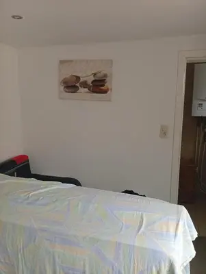 a bedroom with a bed and a picture of shoes on the wall at best price apparemment budget brussels in Brussels