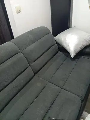a green couch in a room with a bed at best price apparemment budget brussels in Brussels