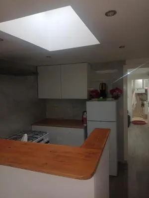 a kitchen with a large light on the ceiling at best price apparemment budget brussels in Brussels