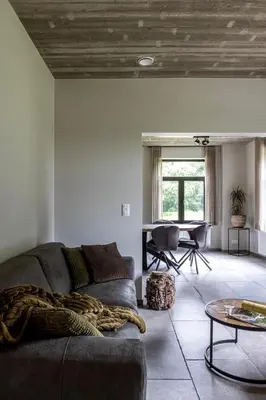 a living room with a couch and a table at Zeer ruime groepswoning voor 24p in Turnhout