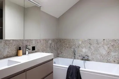 a white bathroom with two sinks and a tub at Zeer ruime groepswoning voor 24p in Turnhout