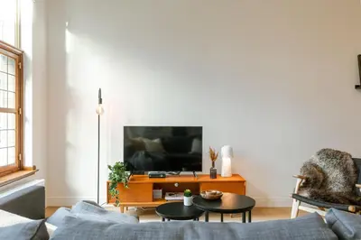 a living room with a couch and a tv at Apartment near Antwerp Cathedral in Antwerp
