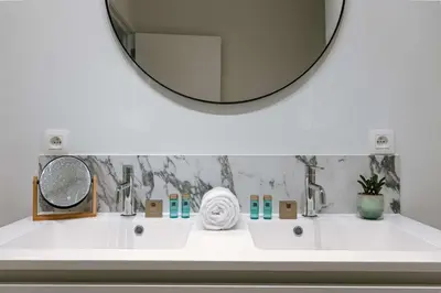 a bathroom with two sinks and a large mirror at Apartment near Antwerp Cathedral in Antwerp