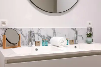 a bathroom with a white sink with a mirror at Apartment near Antwerp Cathedral in Antwerp