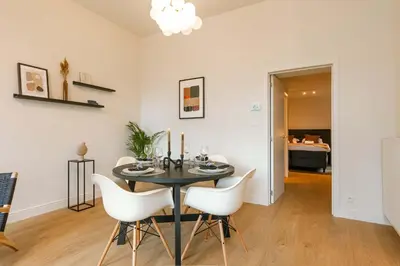 a dining room with a black table and white chairs at Apartment near Antwerp Cathedral in Antwerp