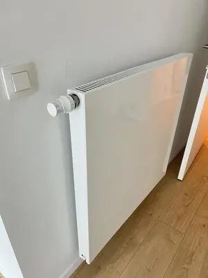 a white radiator on a wall in a room at Modern & Elegant Apartment near Montgomery in Brussels