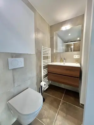a bathroom with a toilet and a sink at Modern & Elegant Apartment near Montgomery in Brussels