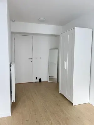 an empty room with a black cat sitting on the floor at Modern & Elegant Apartment near Montgomery in Brussels