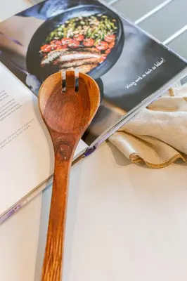 a wooden spoon sitting on top of a book at Bright Duplex near Antwerp Cathedral in Antwerp