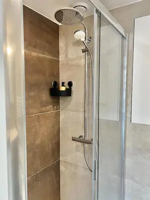 a shower with a glass door in a bathroom at Chic & Bright near Montgomery in Brussels