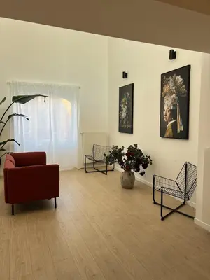 a living room with a couch and a vase with flowers at Chic & Bright near Montgomery in Brussels