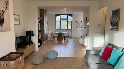 a living room with a couch and a table at Chez Pomme in Brussels