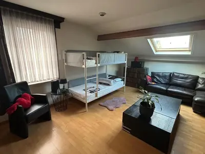 a living room with a couch and a bunk bed at Steves Place Haasdonk in Beveren