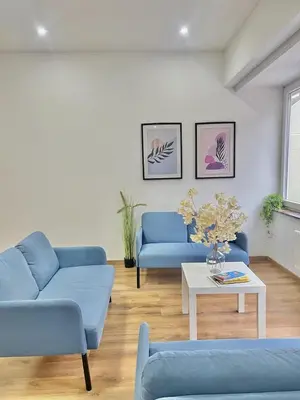 a living room with two blue couches and a table at Spacious Apartment for 6 near Center of Brussels in Brussels