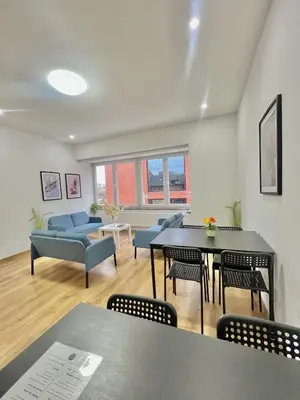 a living room with a table and chairs at Spacious Apartment for 6 near Center of Brussels in Brussels