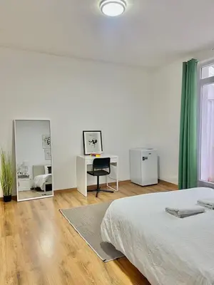 a bedroom with a bed and a desk and mirror at Spacious Apartment for 6 near Center of Brussels in Brussels