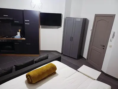 a living room with a couch and a tv at La Perla Appartements Louise RDC in Brussels