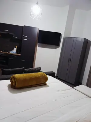 a bed with a yellow pillow on top of it at La Perla Appartements Louise RDC in Brussels