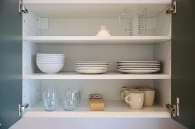 a cabinet with plates and bowls and other dishes at Appartement Ceuppens 5 in Brussels