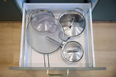 a clear glass box with three metal utensils in it at Appartement Ceuppens 5 in Brussels