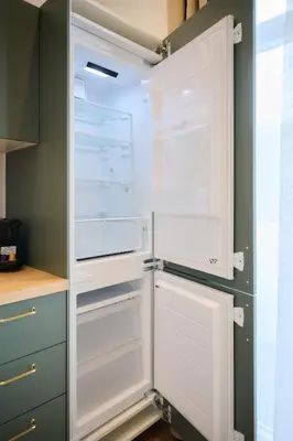 an empty refrigerator with its door open in a kitchen at Appartement Ceuppens 5 in Brussels