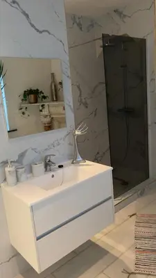 a bathroom with a white sink and a mirror at Majorelle in Brussels