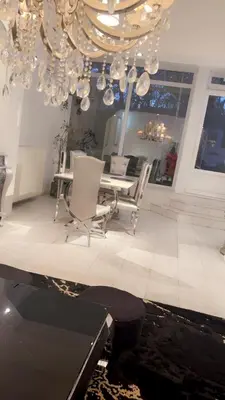 a dining room with a table and chairs and a chandelier at Majorelle in Brussels