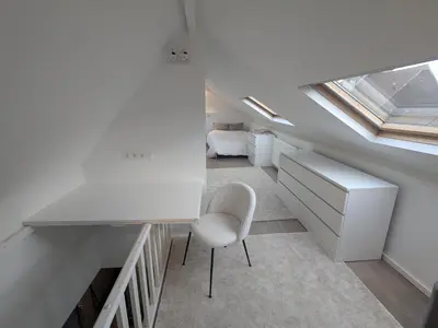 a room with a desk and a chair and a window at upper st in Brussels