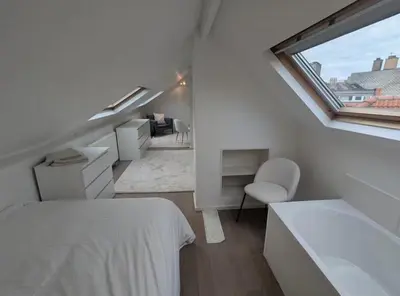 a white room with a bed and a window at upper st in Brussels
