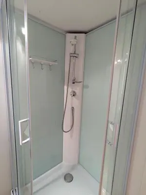 a shower in a bathroom with a glass door at cozy nest basement st gilles in Brussels