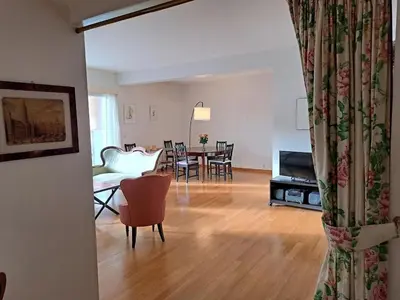 a living room with a couch and a table with chairs at Bright and cosy apartment in Bruxelles in Brussels