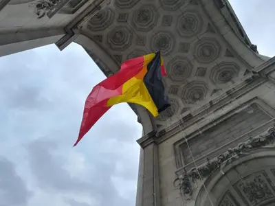 a red yellow and black kite hanging from a building at Bright and cosy apartment in Bruxelles in Brussels