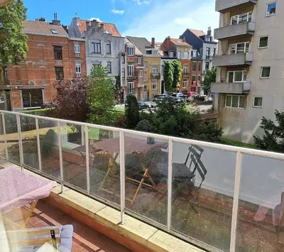 a balcony with a view of a city at Bright and cosy apartment in Bruxelles in Brussels