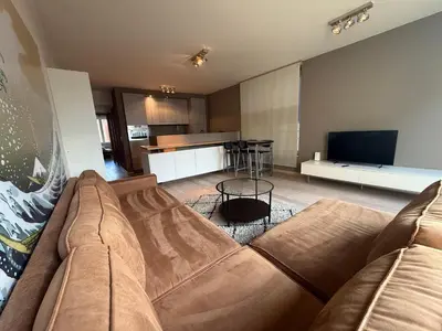 a living room with a couch and a kitchen at Apartment with 2 Bedrooms - Sleeps 6 in Brussels