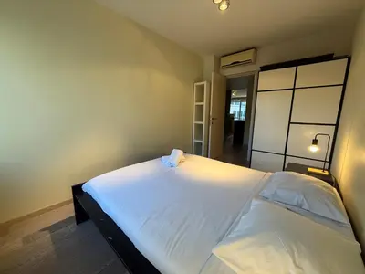 a bedroom with a large white bed in a room at Apartment with 2 Bedrooms - Sleeps 6 in Brussels